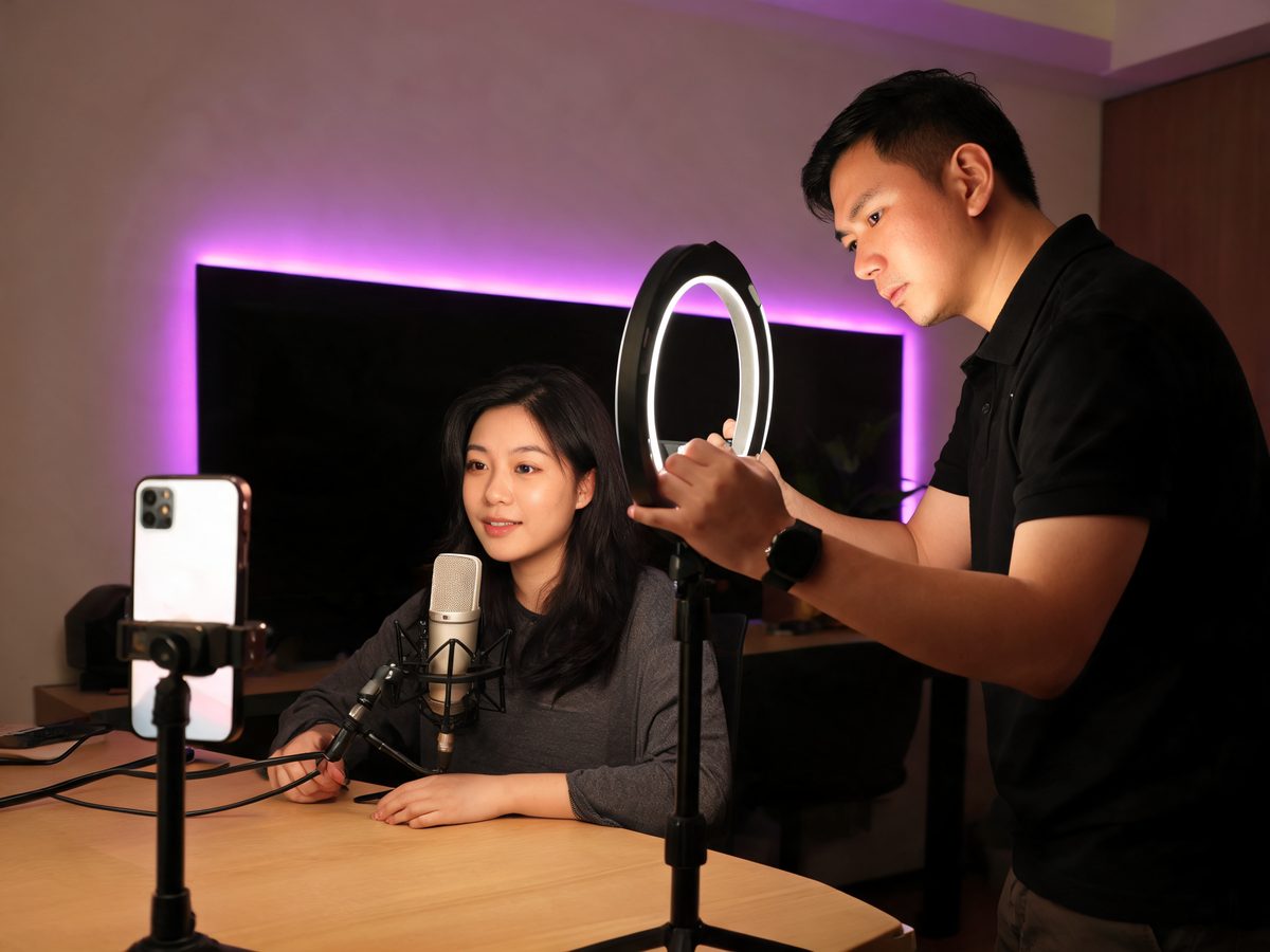 An AT SCAPE talent manager setting up a ring light for a streamer at home